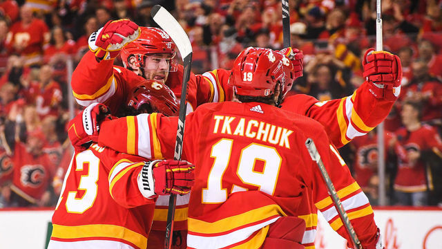 CALGARY, AB - MAY 3: Elias Lindholm #28 of the Calgary Flames celebrates with his teammates after scoring against the Dallas Stars during the first period of Game One of the First Round of the 2022 Stanley Cup Playoffs at Scotiabank Saddledome on May 3, 2022 in Calgary, Alberta, Canada.