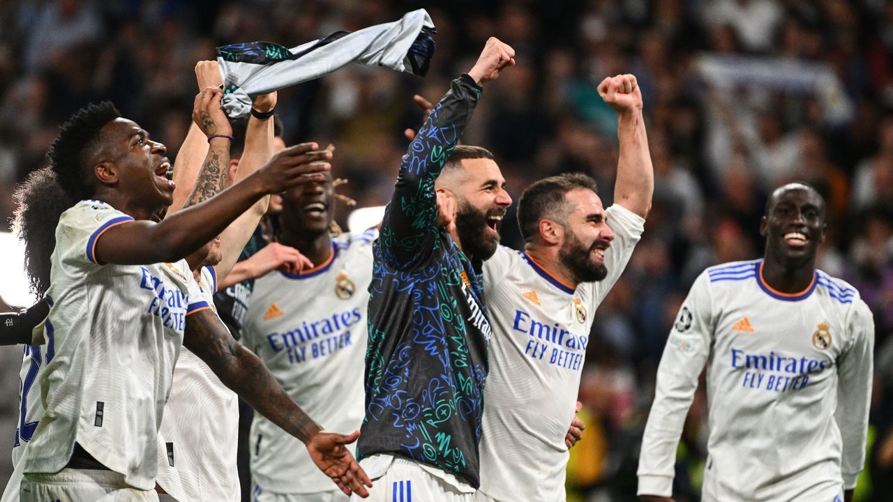 Real Madrid players celebrate their victory at the end of the UEFA Champions League semi-final second leg football match between Real Madrid CF and Manchester City at the Santiago Bernabeu stadium in Madrid on May 4, 2022.