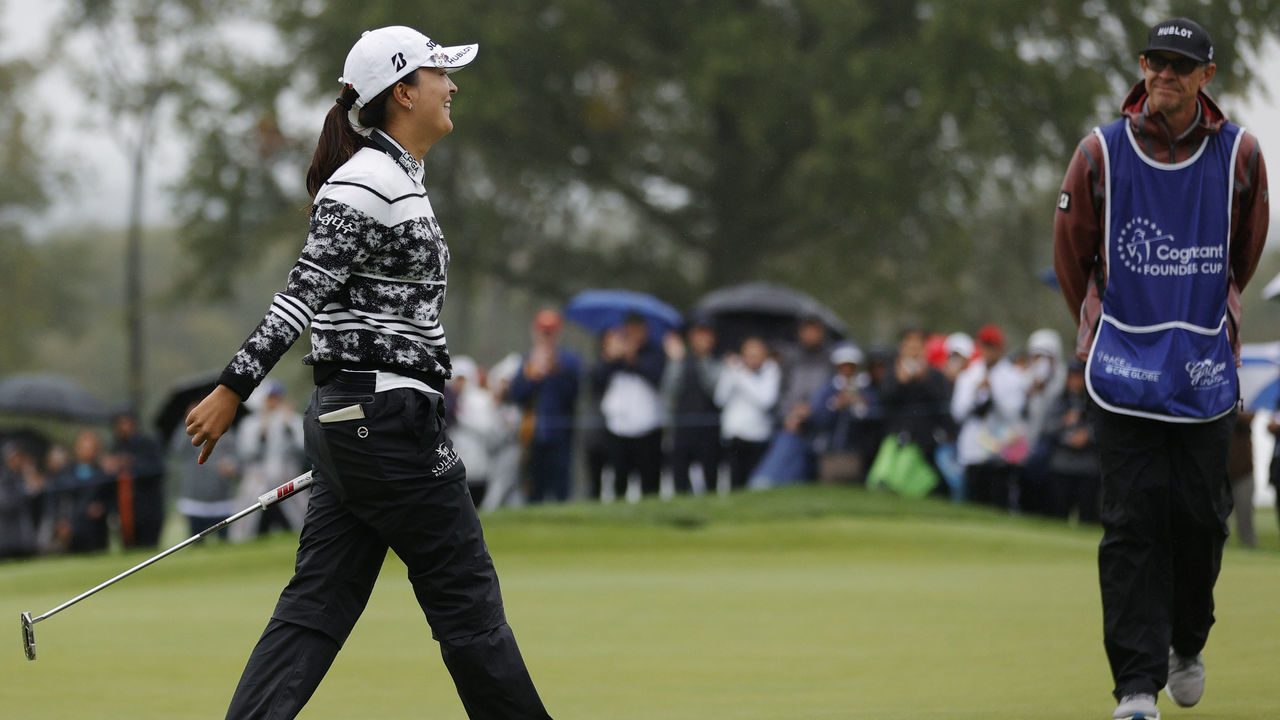 WEST CALDWELL, NEW JERSEY - OCTOBER 10: Jin Young Ko of Korea reacts as caddie Dave Brooker looks on after her win on the 18th green during the final round of the Cognizant Founders Cup at Mountain Ridge Country Club on October 10, 2021 in West Caldwell, New Jersey.