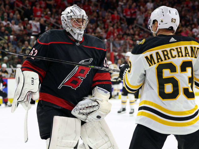 RALEIGH, NC - MAY 4: Goaltender Pyotr Kochetkov #52 of the Carolina Hurricanes squares up after a hit in the crease from Brad Marchand #63 of the Boston Bruins in Game Two of the First Round of the 2022 Stanley Cup Playoffs on May 4, 2022 at PNC Arena in Raleigh, North Carolina.