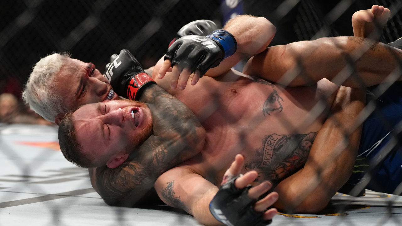 PHOENIX, ARIZONA - MAY 07: (L-R) Charles Oliveira of Brazil secures a rear choke submission against Justin Gaethje in the UFC lightweight championship fight during the UFC 274 event at Footprint Center on May 07, 2022 in Phoenix, Arizona.