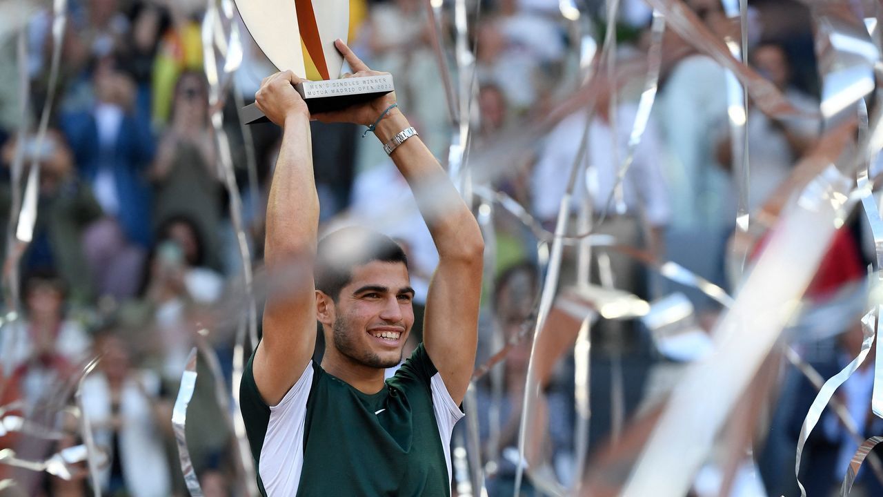 Spain's Carlos Alcaraz celebrates with the trophy after winning the 2022 ATP Tour Madrid Open tennis tournament men's singles final match against Germany's Alexander Zverev at the Caja Magica in Madrid on May 8, 2022.