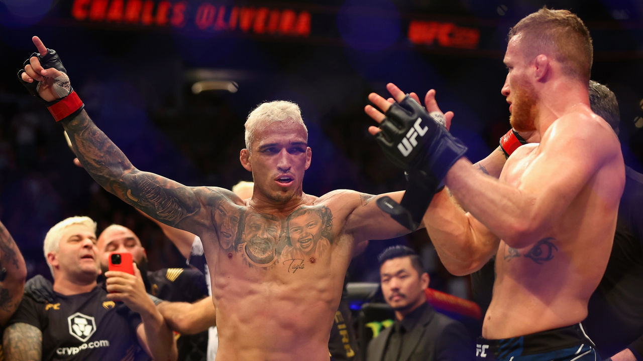 PHOENIX, ARIZONA - MAY 07: Charles Oliveira (L) of Brazil celebrates after his submission victory over Justin Gaethje in their UFC lightweight championship bout during UFC 274 at Footprint Center on May 07, 2022 in Phoenix, Arizona.