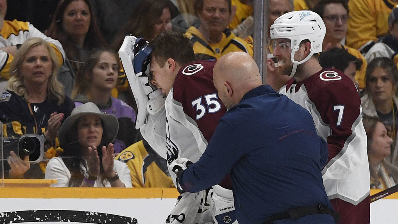 NASHVILLE, TN - MAY 07: Colorado Avalanche goaltender Darcy Kuemper (35) get helped off the ice from a trainer and Colorado Avalanche defenseman Devon Toews (7) late in the period of the third game of the first round of the Stanley Cup playoffs against the Nashville Predators at Bridgestone Arena May 07, 2022. Kuemper did not return to the game.