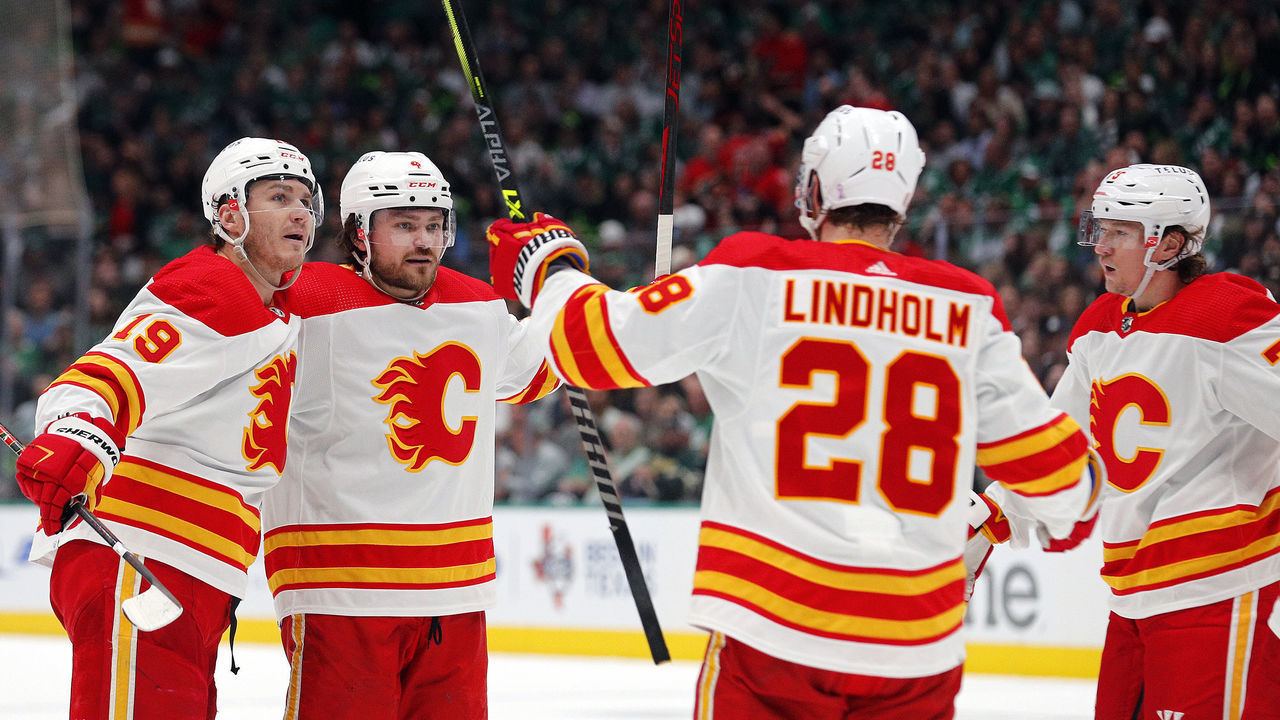 DALLAS, TEXAS - MAY 09: Matthew Tkachuk #19, Rasmus Andersson #4, Elias Lindholm #28, and Tyler Toffoli #73 of the Calgary Flames celebrate a second period goal against the Dallas Stars in Game Four of the First Round of the 2022 Stanley Cup Playoffs at American Airlines Center on May 09, 2022 in Dallas, Texas.