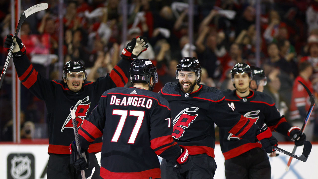 RALEIGH, NORTH CAROLINA - MAY 10: Tony DeAngelo #77 of the Carolina Hurricanes celebrates with his team following his first period goal against the Boston Bruins in Game Five of the First Round of the 2022 Stanley Cup Playoffs at PNC Arena on May 10, 2022 in Raleigh, North Carolina.