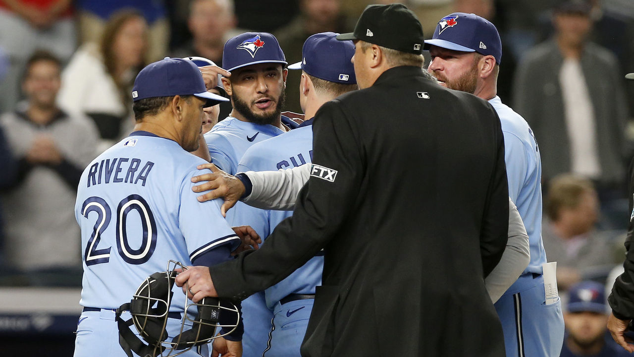 NEW YORK, NEW YORK - MAY 10: Yimi Garcia #93 of the Toronto Blue Jays is restrained by teammates after being ejected by home plate umpire Lance Barrett for hitting a New York Yankees batter in the sixth inning at Yankee Stadium on May 10, 2022 in New York City.