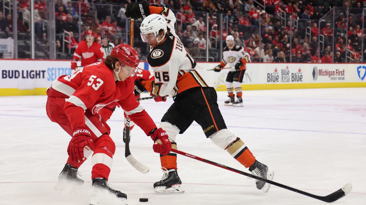 DETROIT, MICHIGAN - JANUARY 31: Trevor Zegras #46 of the Anaheim Ducks tries to get around the stick of Moritz Seider #53 of the Detroit Red Wings during the third period at Little Caesars Arena on January 31, 2022 in Detroit, Michigan.