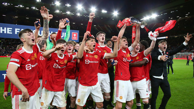 MANCHESTER, ENGLAND - MAY 11: Rhys Bennett of Manchester United lifts the FA Youth Cup trophy following victory in the FA Youth Cup Final match between Manchester United and Nottingham Forest at Old Trafford on May 11, 2022 in Manchester, England.