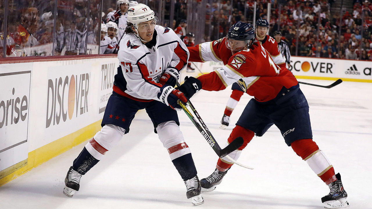 SUNRISE, FL - MAY 11: Anton Lundell #15 of the Florida Panthers attempts to block T.J. Oshie #77 of the Washington Capitals during second period action in Game Five of the First Round of the 2022 Stanley Cup Playoffs at the FLA Live Arena on May 11, 2022 in Sunrise, Florida.