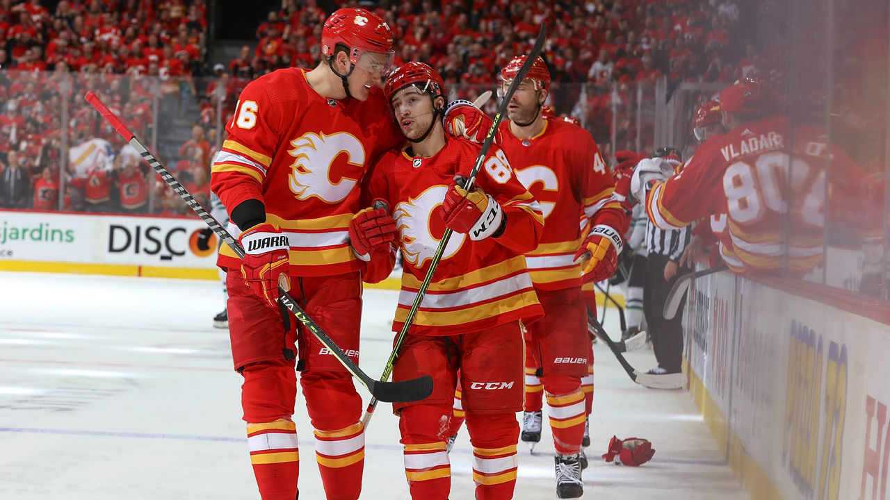 CALGARY, AB - MAY 11: Nikita Zadorov #16 and Andrew Mangiapane #88 of the Calgary Flames celebrate after a goal against the Dallas Stars in Game Five of the First Round of the 2022 Stanley Cup Playoffs at Scotiabank Saddledome on May 11, 2022 in Calgary, Alberta, Canada.