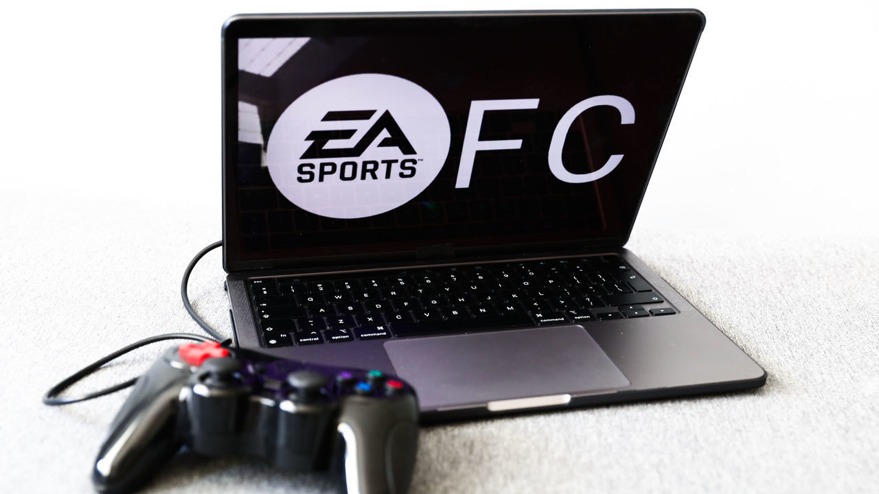A gamepad and EA Sports logo displayed on a laptop screen are seen in this illustration photo taken in Krakow, Poland on May 11, 2022. EA Sports has announced that it will rename it's football video game from FIFA to EA Sports FC. (Photo illustration by Jakub Porzycki/NurPhoto via Getty Images)