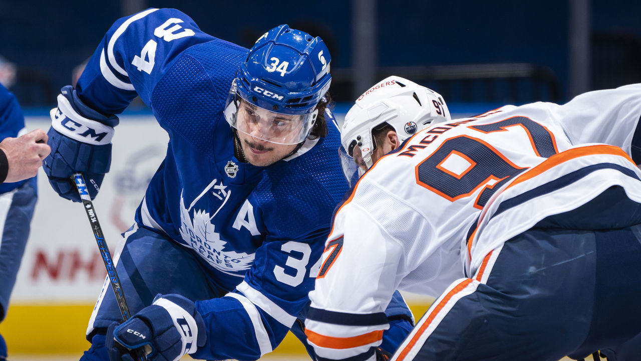 TORONTO, ON - MARCH 29: Auston Matthews #34 of the Toronto Maple Leafs faces off against Connor McDavid #97 of the Edmonton Oilers during the first period at the Scotiabank Arena on March 29, 2021 in Toronto, Ontario, Canada.