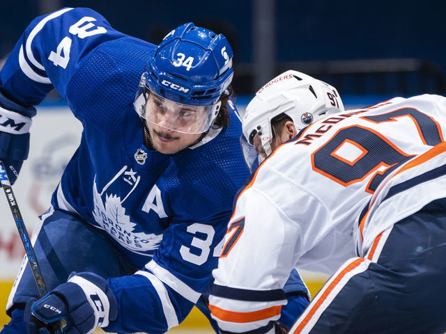 TORONTO, ON - MARCH 29: Auston Matthews #34 of the Toronto Maple Leafs faces off against Connor McDavid #97 of the Edmonton Oilers during the first period at the Scotiabank Arena on March 29, 2021 in Toronto, Ontario, Canada.