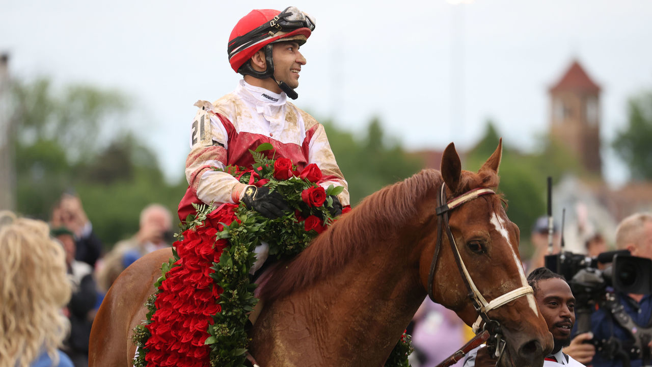 LOUISVILLE, KY - MAY 07: Jockey Sonny Leon aboard Rich Strike (21) is paraded in the winner's circle after winning the148th running of the Kentucky Derby on May 7th, 2022, at Churchill Downs in Louisville, Kentucky.