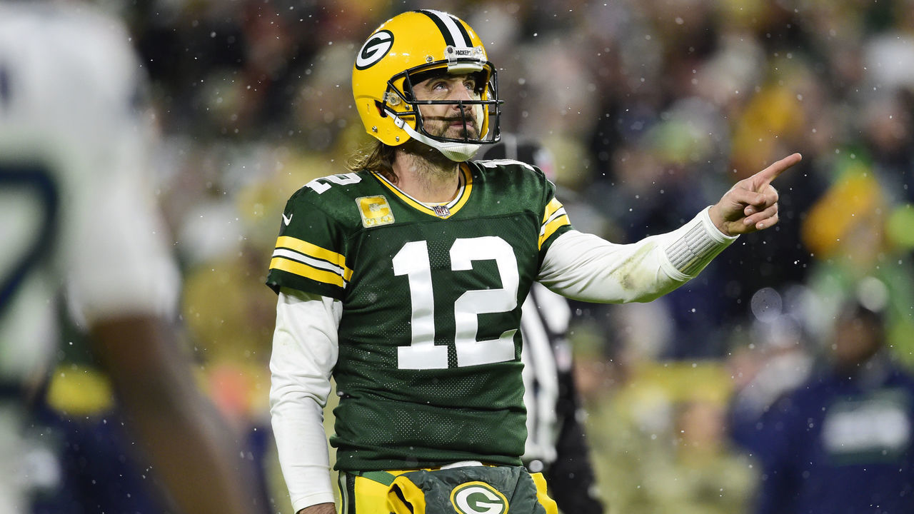 GREEN BAY, WISCONSIN - NOVEMBER 14: Aaron Rodgers #12 of the Green Bay Packers signals for a first down against the Seattle Seahawks in the second half at Lambeau Field on November 14, 2021 in Green Bay, Wisconsin.