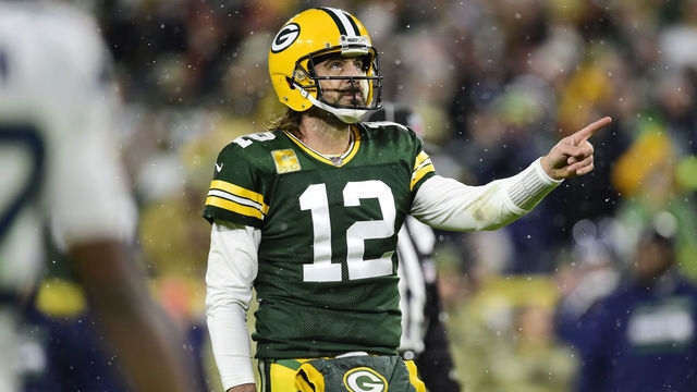 GREEN BAY, WISCONSIN - NOVEMBER 14: Aaron Rodgers #12 of the Green Bay Packers signals for a first down against the Seattle Seahawks in the second half at Lambeau Field on November 14, 2021 in Green Bay, Wisconsin.