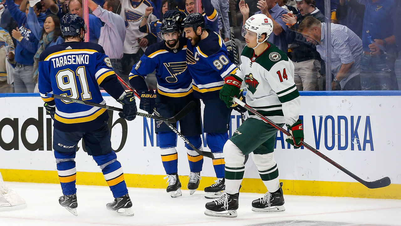 ST LOUIS, MO - MAY 12: Joel Eriksson Ek #14 of the Minnesota Wild skates past Nick Leddy #4, Ryan OReilly #90, and Vladimir Tarasenko #91 of the St. Louis Blues as they celebrate Leedy's goal during the first period in Game Six of the First Round of the 2022 Stanley Cup Playoffs at the Enterprise Center on May 12, 2022 in St Louis, Missouri.