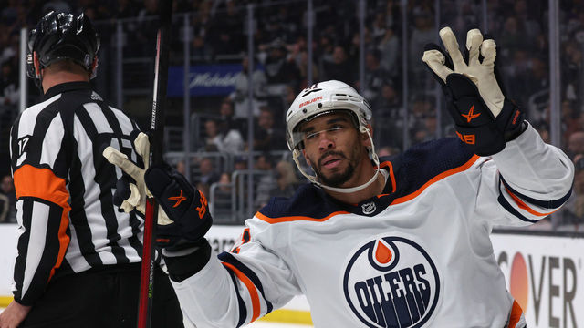LOS ANGELES, CALIFORNIA - MAY 12: Evander Kane #91 of the Edmonton Oilers celebrates his empty net goal behind referee Frederick L'Ecuyer #17 during the third period in a 4-2 Oilers win in Game Six of the First Round of the 2022 Stanley Cup Playoffs at Crypto.com Arena on May 12, 2022 in Los Angeles, California.