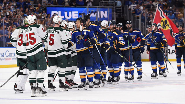ST. LOUIS, MO - MAY 12: Members St. Louis Blues shake hands with the Minnesota Wild after beating them in Game Six of the First Round of the 2022 Stanley Cup Playoffs at the Enterprise Center on May 12, 2022 in St. Louis, Missouri.