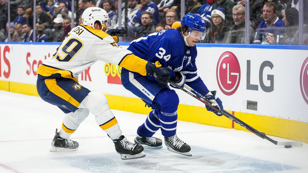 TORONTO, ON - NOVEMBER 16: Auston Matthews #34 of the Toronto Maple Leafs plays the puck against Roman Josi #59 of the Nashville Predators during the third period at the Scotiabank Arena on November 16, 2021 in Toronto, Ontario, Canada.