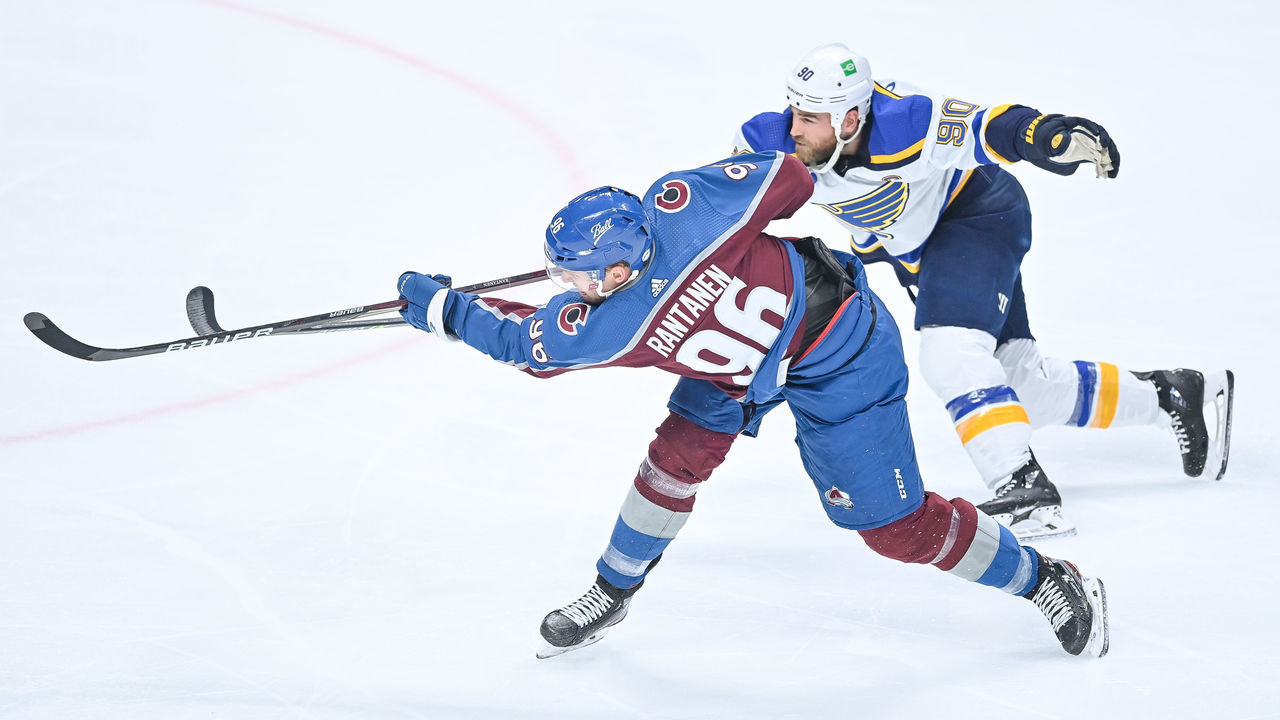 DENVER, CO - MAY 19: Colorado Avalanche right wing Mikko Rantanen (96) shoots under coverage by St. Louis Blues center Ryan O'Reilly (90) during a Stanley Cup Playoffs first round game between the St. Louis Blues and the Colorado Avalanche at Ball Arena in Denver, Colorado on May 19, 2021.