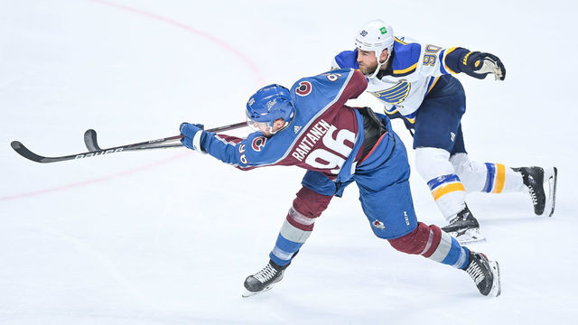 DENVER, CO - MAY 19: Colorado Avalanche right wing Mikko Rantanen (96) shoots under coverage by St. Louis Blues center Ryan O'Reilly (90) during a Stanley Cup Playoffs first round game between the St. Louis Blues and the Colorado Avalanche at Ball Arena in Denver, Colorado on May 19, 2021.