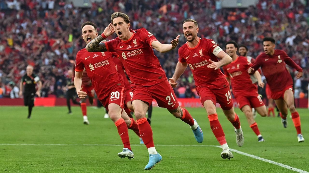 Liverpool's Greek defender Kostas Tsimikas (2nd R) celebrates with teammates after scoring a goal during the penalty sessions of the English FA Cup final football match between Chelsea and Liverpool, at Wembley stadium, in London, on May 14, 2022. - Liverpool wins the FA cup final - NOT FOR MARKETING OR ADVERTISING USE / RESTRICTED TO EDITORIAL USE