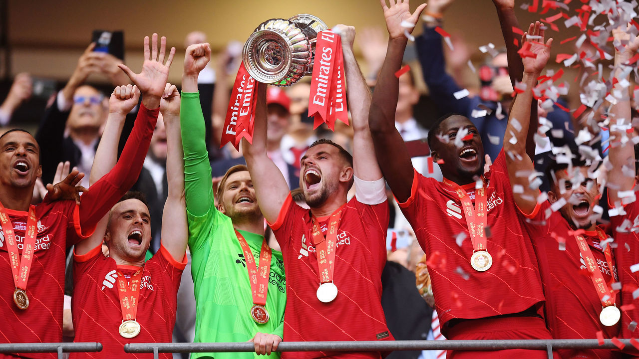 LONDON, ENGLAND - MAY 14: Jordan Henderson of Liverpool lifts The Emirates FA Cup trophy after their sides victory during The FA Cup Final match between Chelsea and Liverpool at Wembley Stadium on May 14, 2022 in London, England.