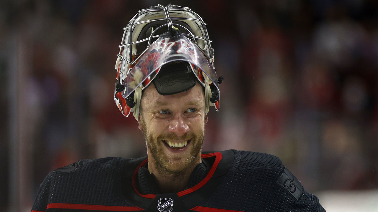 RALEIGH, NORTH CAROLINA - MAY 14: Antti Raanta #32 of the Carolina Hurricanes celebrates their 3-2 victory over the Boston Bruins in Game Seven of the First Round of the 2022 Stanley Cup Playoffs at PNC Arena on May 14, 2022 in Raleigh, North Carolina.