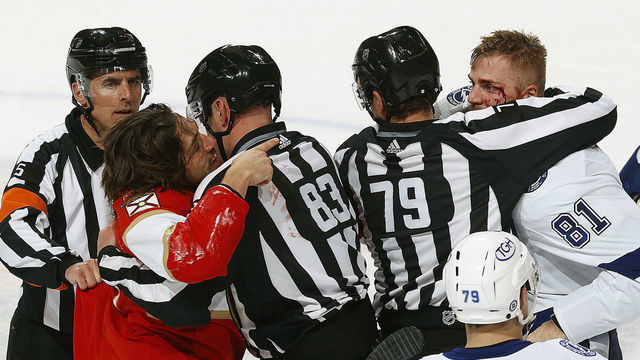 SUNRISE, FL - APRIL 24: Linesman Kiel Murchison #79 and linesman Matt MacPherson #83 break up a fight between Ryan Lomberg #94 of the Florida Panthers and Erik Cernak #81 of the Tampa Bay Lightning at the FLA Live Arena on April 24, 2022 in Sunrise, Florida.