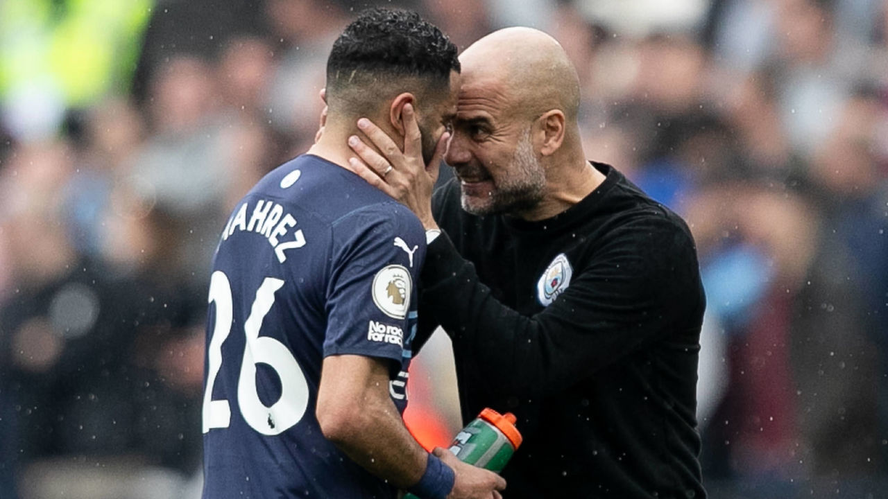 Josep Guardiola manager of Manchester City gives instructions Riyad Mahrez of Manchester City during the Premier League match between West Ham United and Manchester City at the London Stadium, Stratford on Sunday 15th May 2022.