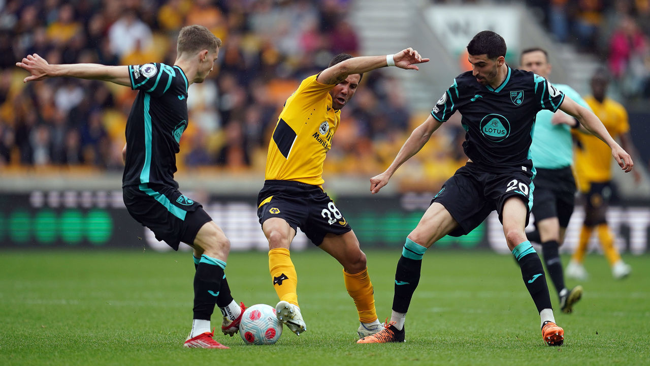 Wolverhampton Wanderers' Joao Moutinho battles for the ball with Norwich City's Pierre Lees-Melou (right) and Jacob Sorensen during the Premier League match at Molineux Stadium, Wolverhampton. Picture date: Sunday May 15, 2022.