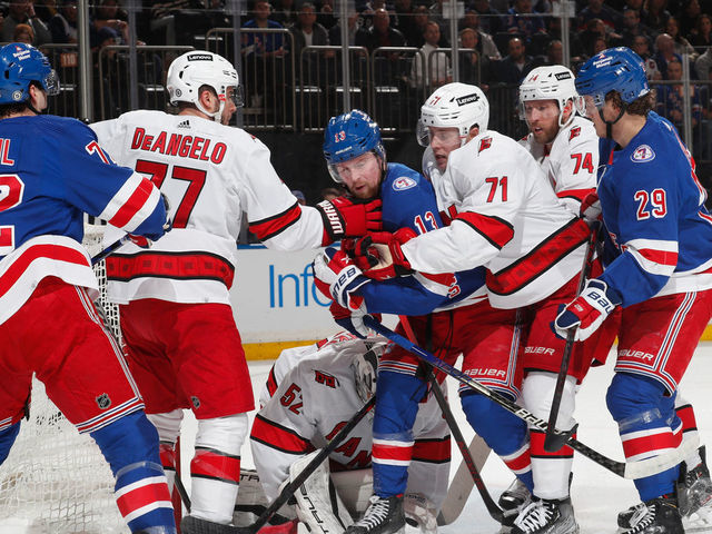 NEW YORK, NY - APRIL 26: Alexis Lafreniere #13 of the New York Rangers battles at the net against Jesper Fast #71 of the Carolina Hurricanes at Madison Square Garden on April 26, 2022 in New York City.