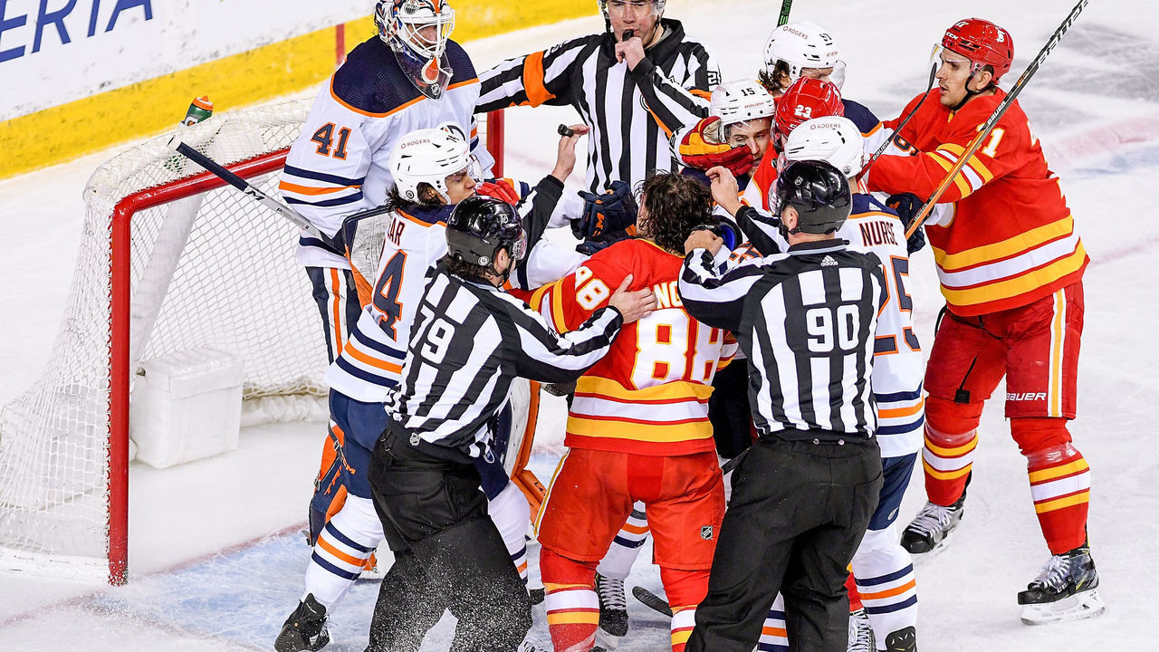 CALGARY, AB - APRIL 10: Calgary Flames Right Wing Andrew Mangiapane (88) and Edmonton Oilers Defenceman William Lagesson (84) rough one another after the whistle during the second period of an NHL game where the Calgary Flames hosted the Edmonton Oilers on April 10, 2021, at the Scotiabank Saddledome in Calgary, AB.