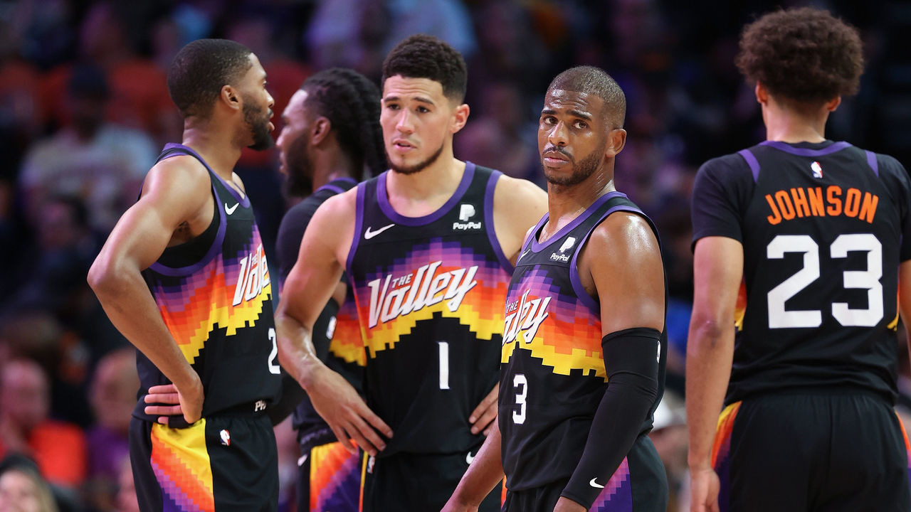 PHOENIX, ARIZONA - MAY 15: Chris Paul #3 of the Phoenix Suns stands on the court with Mikal Bridges #25, Devin Booker #1 and Cameron Johnson #23 during the first half of Game Seven of the Western Conference Second Round NBA Playoffs at Footprint Center on May 15, 2022 in Phoenix, Arizona. The Mavericks defeated the Suns 123-90.