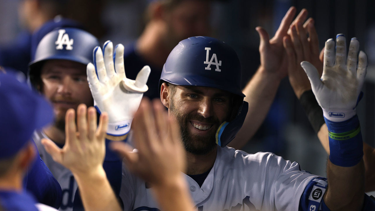 LOS ANGELES, CALIFORNIA - MAY 16: Chris Taylor #3 of the Los Angeles Dodgers celebrates his two run homerun in the dugout ahead of Max Muncy #13, to take a5-2 lead over the Arizona Diamondbacks, during the sixth inning at Dodger Stadium on May 16, 2022 in Los Angeles, California.