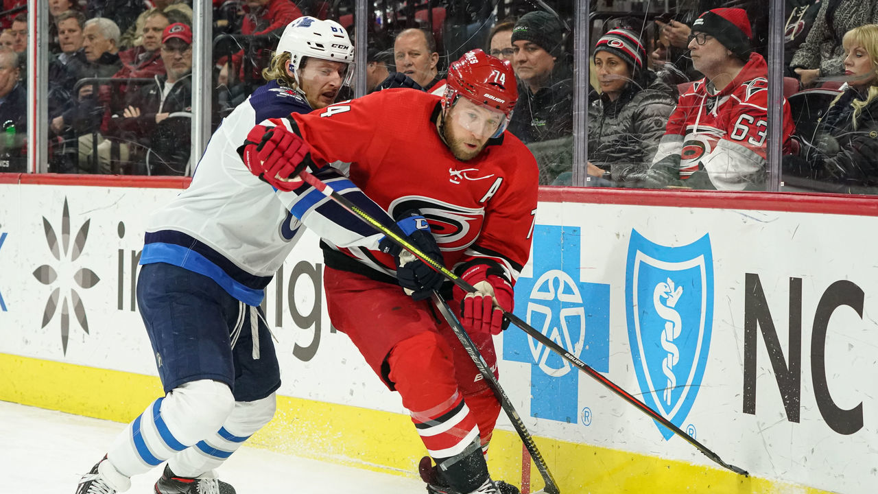 RALEIGH, NC - JANUARY 21: Carolina Hurricanes Defenceman Jaccob Slavin (74) is chased around the boards by Winnipeg Jets Left Wing Kyle Connor (81) during a game between the Carolina Hurricanes and the Winnipeg Jets on January 21, 2020 at the PNC Arena in Raleigh, NC.