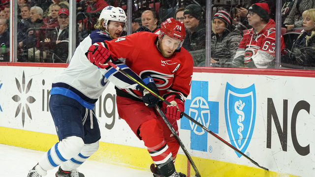 RALEIGH, NC - JANUARY 21: Carolina Hurricanes Defenceman Jaccob Slavin (74) is chased around the boards by Winnipeg Jets Left Wing Kyle Connor (81) during a game between the Carolina Hurricanes and the Winnipeg Jets on January 21, 2020 at the PNC Arena in Raleigh, NC.