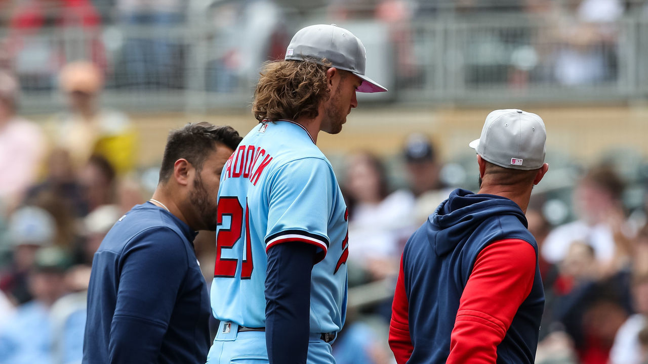 MINNEAPOLIS, MN - MAY 08: Pitcher Chris Paddack #20 of the Minnesota Twins leaves the game with a medical trainer in the third inning against the Oakland Athletics at Target Field on May 8, 2022 in Minneapolis, Minnesota. Teams across the league are wearing pink today in honor of Mother's Day.