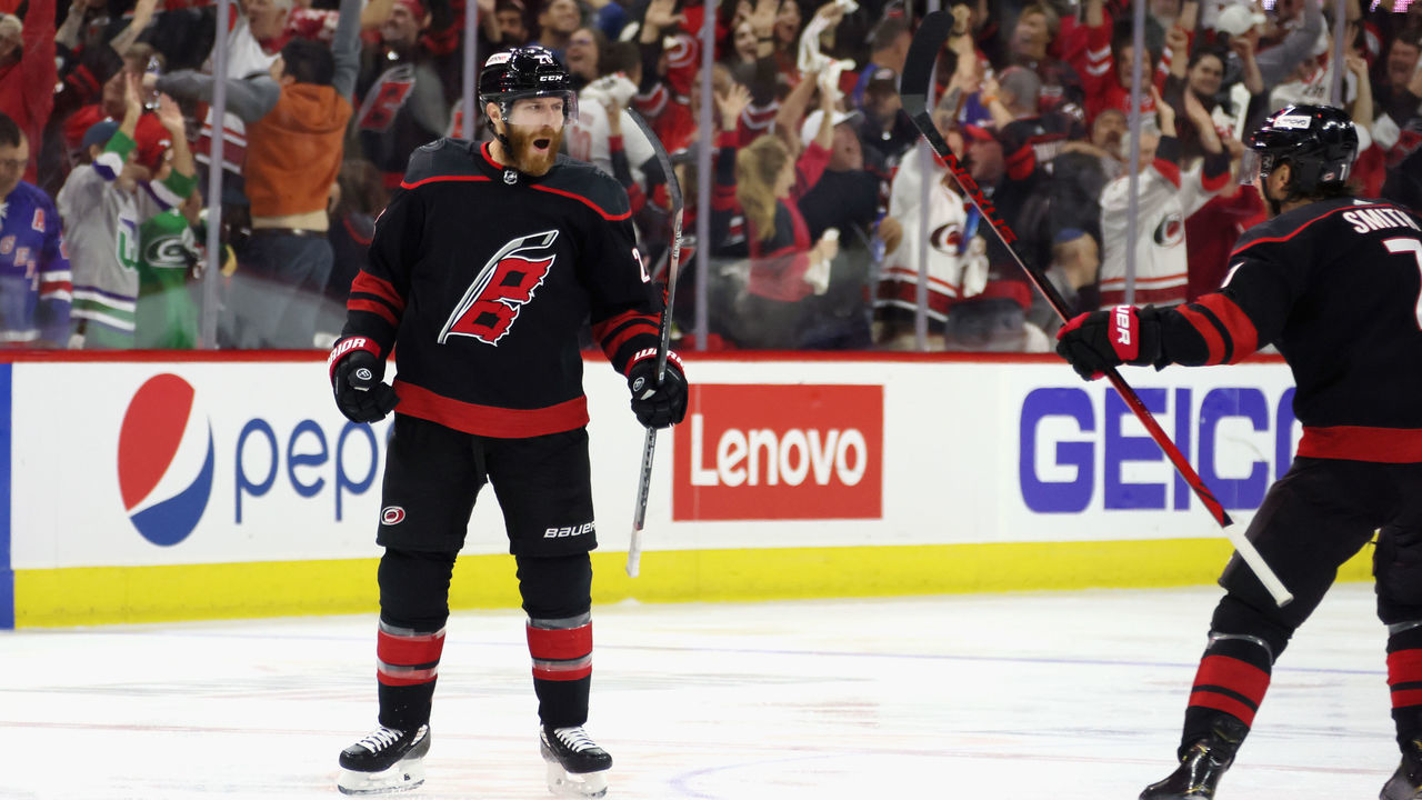 RALEIGH, NORTH CAROLINA - MAY 18: Ian Cole #28 of the Carolina Hurricanes scores at 3:12 of overtime against the New York Rangers in Game One of the Second Round of the 2022 Stanley Cup Playoffs at PNC Arena on May 18, 2022 in Raleigh, North Carolina. The Hurricanes defeated the Rangers 2-1 in overtime.