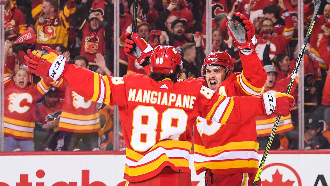 CALGARY, AB - MAY 18: Andrew Mangiapane #88 (L) of the Calgary Flames celebrates with teammate Mikael Backlund #11 after scoring against the Edmonton Oilers during the first period of Game One of the Second Round of the 2022 Stanley Cup Playoffs at Scotiabank Saddledome on May 18, 2022 in Calgary, Alberta, Canada.
