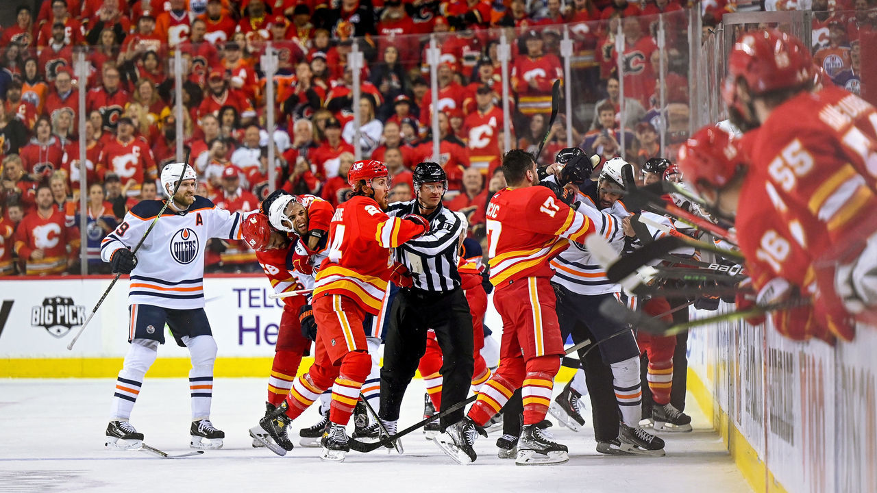 CALGARY, AB - MAY 18: Edmonton Oilers Left Wing Evander Kane (91), Calgary Flames Left Wing Milan Lucic (17), Edmonton Oilers Center Connor McDavid (97), Calgary Flames Defenceman Michael Stone (26) and teammates get physical after a whistle during the first period of game 1 of the second round of the NHL Stanley Cup Playoffs between the Calgary Flames and the Edmonton Oilers on May 18, 2022, at the Scotiabank Saddledome in Calgary, AB.