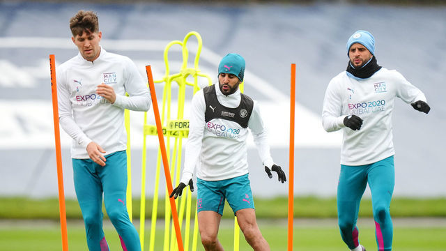 MANCHESTER, ENGLAND - APRIL 04: Manchester City's John Stones, Riyad Mahrez and Kyle Walker in action during training at Manchester City Football Academy on April 4, 2022 in Manchester, England.