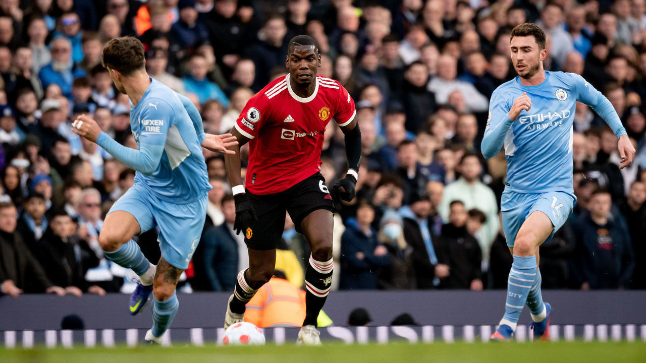 MANCHESTER, ENGLAND - MARCH 06: Paul Pogba of Manchester United in action with John Stones of Manchester City during the Premier League match between Manchester City and Manchester United at Etihad Stadium on March 06, 2022 in Manchester, England.