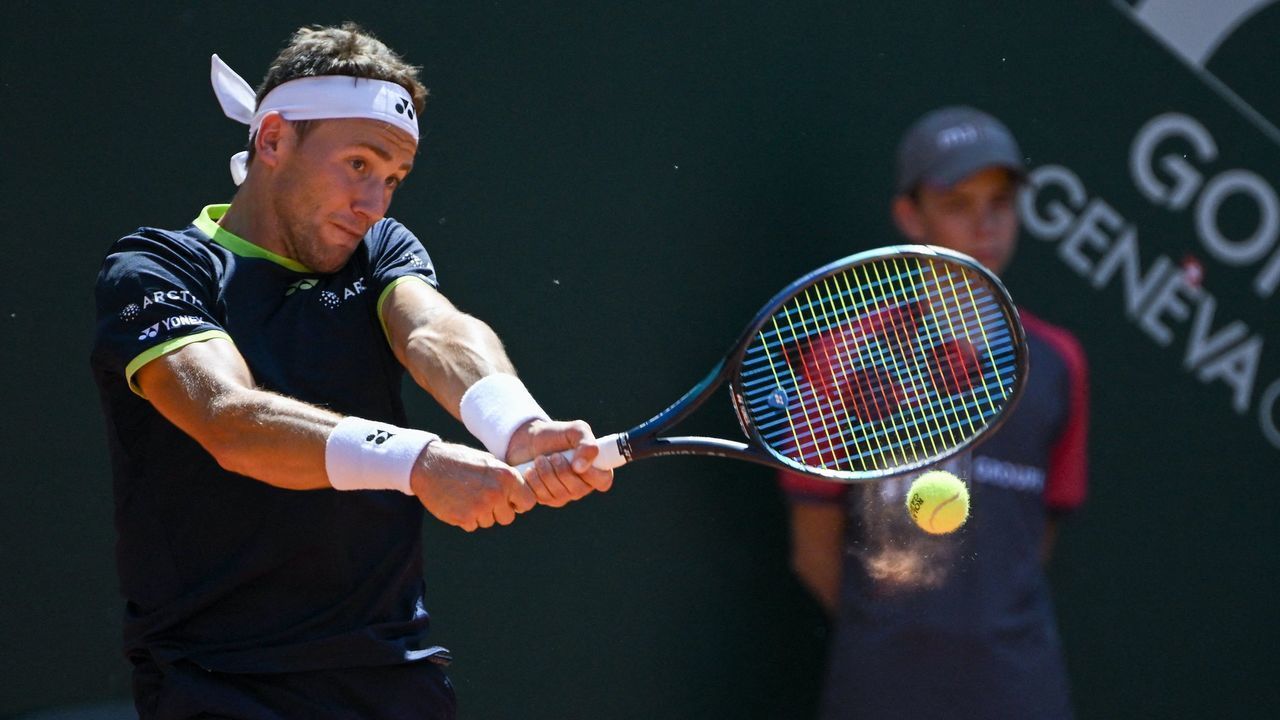 Norway's Casper Ruud returns a ball to US player Reilly Opelka during their semi-final match at ATP 250 Geneva Open tennis tournament in Geneva on May 20, 2022.