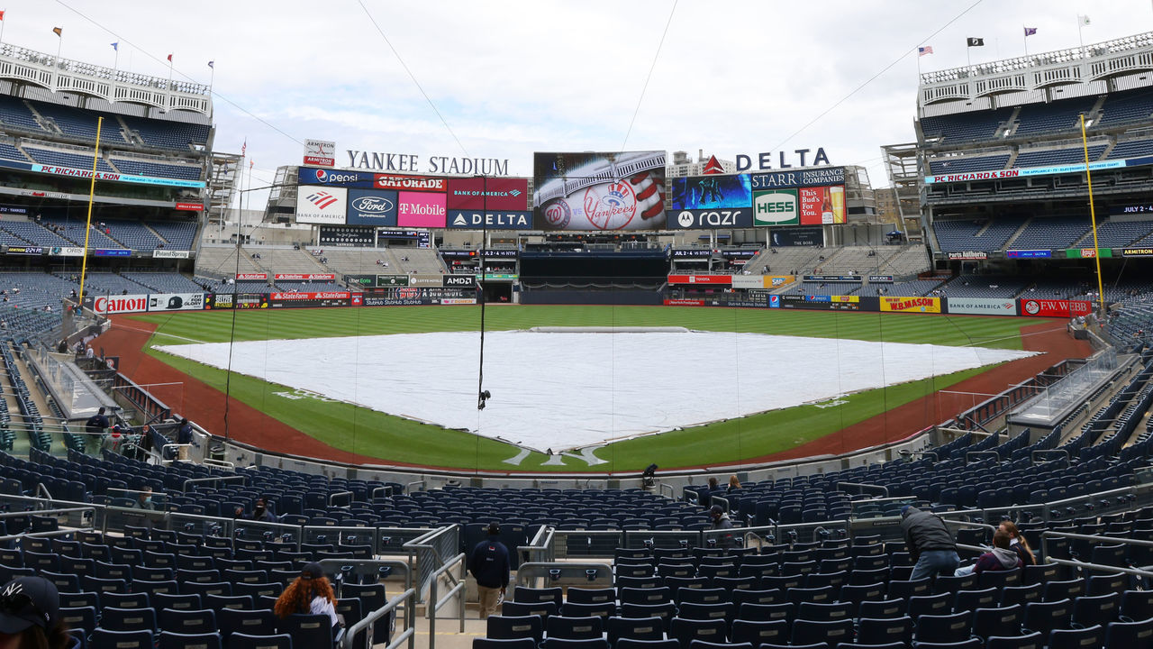 NEW YORK, NY - MAY 08: A tarp covers the infield during a rain delay pushing back the start of a game between the Washington Nationals and New York Yankees at Yankee Stadium on May 8, 2021 in New York City.