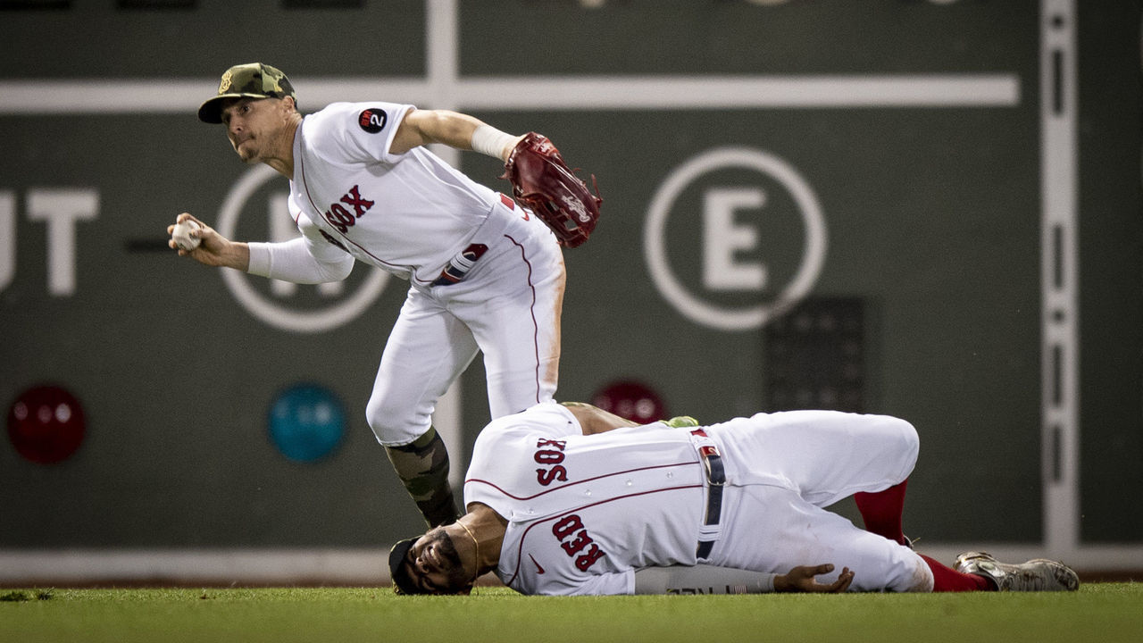 BOSTON, MA - MAY 20: Xander Bogaerts #2 of the Boston Red Sox reacts after colliding with Alex Verdugo #99 of the Boston Red Sox while attempting to catch a fly ball during the eighth inning of a game against the Seattle Mariners on May 20, 2022 at Fenway Park in Boston, Massachusetts.