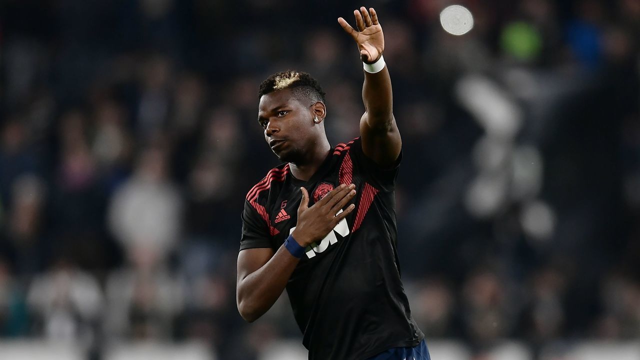 Manchester United's French midfielder Paul Pogba waves during a warm up session prior to the UEFA Champions League group H football match Juventus vs Manchester United at the Allianz stadium in Turin on November 7, 2018.