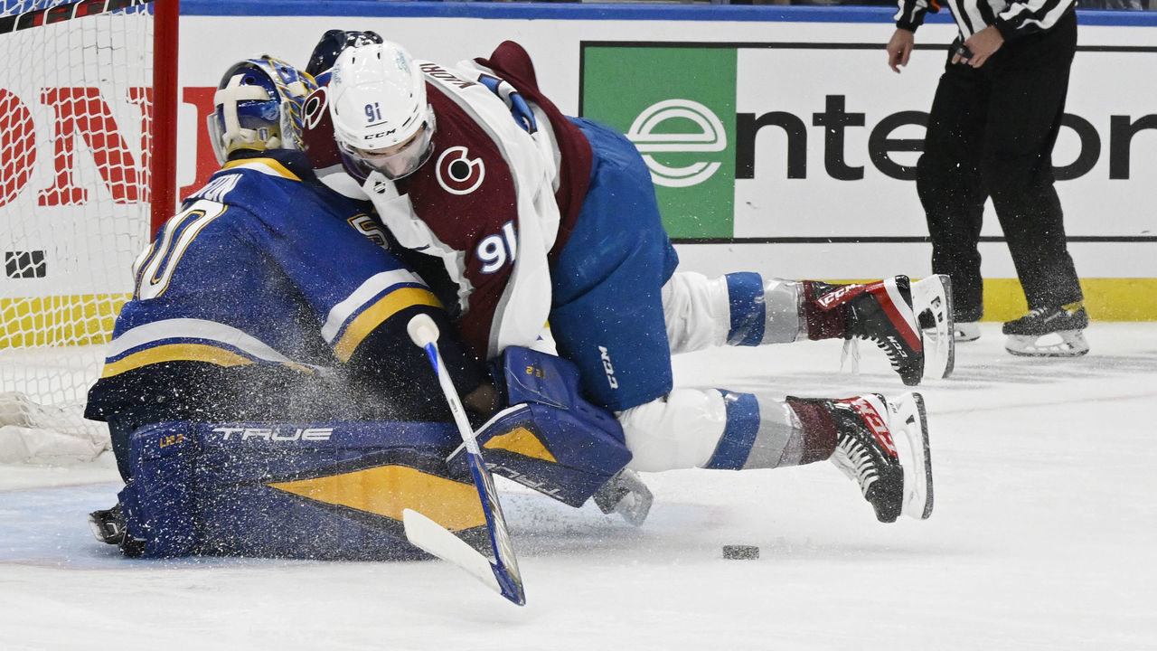 ST. LOUIS, CO - MAY 21: Colorado Avalanche center Nazem Kadri (91) smashes into St. Louis Blues goaltender Jordan Binnington (50) in the first period at The Enterprise Center during game three of the second round of the NHL playoffs at the Enterprise Center May 21, 2022. Binnington left the game with an injury. "n